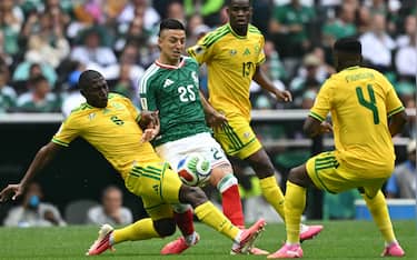 South Africa's defender #06 Aubrey Modiba, Mexico's midfielder #25 Roberto Alvarado, South Africa's midfielder #13 Sphephelo Sithole and South Africa's midfielder #04 Teboho Mokoena fight for the ball during the 2026 World Cup Group A football match between Mexico and South Africa at the Mexico City Stadium in Mexico City on June 11, 2026. (Photo by Yuri CORTEZ / AFP)