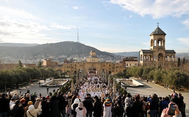 TBILISI, GEORGIA - JANUARY 07: Georgians participate in a traditional "Alilo" religious procession and march towards the Holy Trinity Cathedral during the Orthodox Christmas celebration, on January 07, 2024 in Tbilisi, Georgia. Orthodox Georgians celebrate Christmas on January 7, following the old Julian calendar. (Photo by Nicolo Vincenzo Malvestuto/Getty Images)