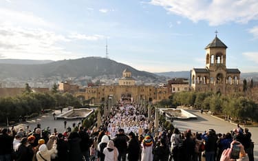 TBILISI, GEORGIA - JANUARY 07: Georgians participate in a traditional "Alilo" religious procession and march towards the Holy Trinity Cathedral during the Orthodox Christmas celebration, on January 07, 2024 in Tbilisi, Georgia. Orthodox Georgians celebrate Christmas on January 7, following the old Julian calendar. (Photo by Nicolo Vincenzo Malvestuto/Getty Images)