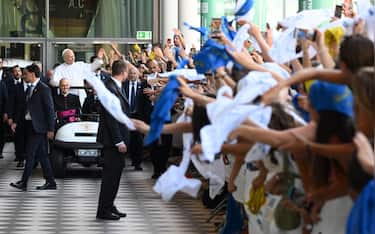 Pope Leo XIV greets the faithful as he arrives for the 47th Meeting for Friendship Among Peoples, organized by the Communion and Liberation movement in Rimini, Italy, 22 August 2026.    ANSA/ETTORE FERRARI
