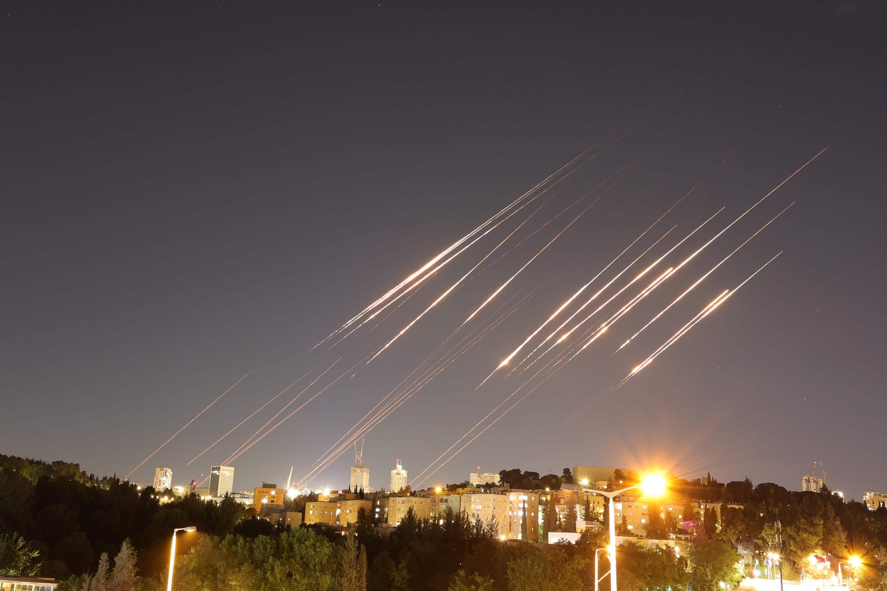 epa12175801 A slow exposure picture shows ballistic missiles above Jerusalem, 14 June 2025. Israel's military has identified missiles being launched from Iran towards the territory of Israel in retaliation following overnight airstrikes on Iranian targets.  EPA/ABIR SULTAN