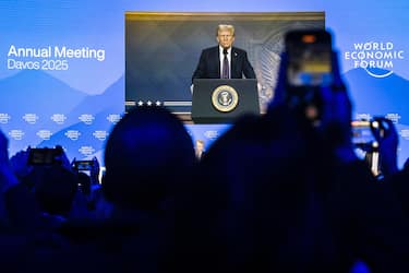 epa11847595 US President Donald Trump is shown on a screen as he addresses via videolink a plenary session in the Congress Hall during the 55th annual meeting of the World Economic Forum (WEF) in Davos, Switzerland, 23 January 2025. The World Economic Forum annual meeting brings together entrepreneurs, scientists, corporate and political leaders in Davos and takes place from January 20 to 24.  EPA/MICHAEL BUHOLZER