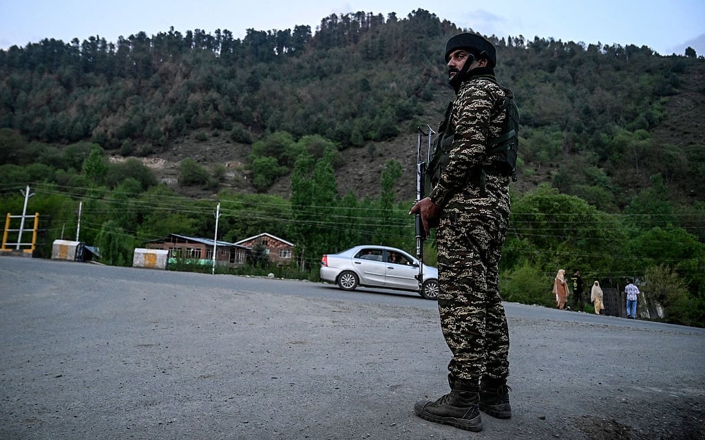 An Indian paramilitary personnel stands guard near Pahalgam, south of Srinagar, on April 22, 2025, following an attack. At least 24 people were killed in Indian-administered Kashmir when gunmen opened fire on tourists on April 22, a senior police officer told AFP, with authorities calling it the worst attack on civilians in years. Prime Minister Narendra Modi decried the "heinous act" in the summer retreat of Pahalgam, pledging the attackers "will be brought to justice". (Photo by Tauseef MUSTAFA / AFP) (Photo by TAUSEEF MUSTAFA/AFP via Getty Images)          