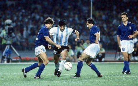 NAPLES, ITALY - JULY 03:  Diego armando Maradona (C) of Argentina  competes for the ball with (l-r9 Franco Baresi and Luigi De Agostini of Italy during the FIFA World Cup 1990 match between Italy and Argentina at Stadio San Paolo on July 03, 1990 in Naples, Italy.  (Photo by Alessandro Sabattini/Getty Images)