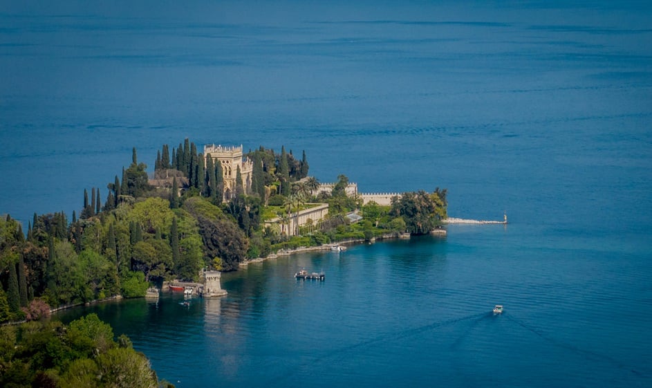 A drone view of Isola del Garda on Lake Garda as the lake's water levels recede due to a severe drought in Manerba, Italy, on April 28, 2023. The water level has dropped to just 45.8 cm above the hydrometric zero, leaving the basin at 25% of its water capacity. Summer irrigation and the operation of several hydroelectric plants are at risk. The primary cause is low winter precipitation and insufficient snow accumulation. (Photo by Manuel Romano/NurPhoto via Getty Images)