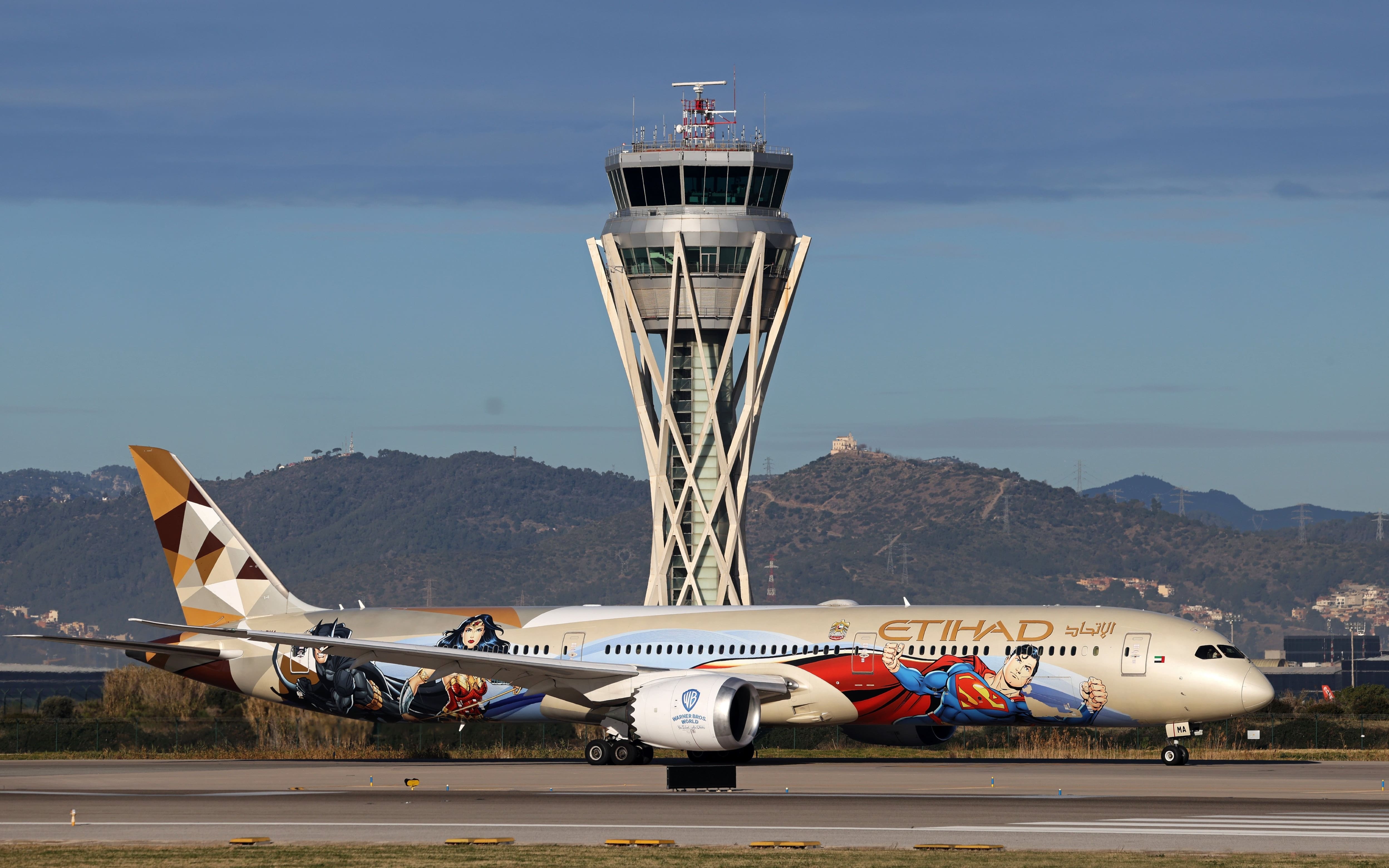 IPA53289745 - Mandatory Credit: Photo by Urbanandsport/NurPhoto/Shutterstock (15117201i).An Etihad Boeing 787-10 Dreamliner, with special Warner Bros. World livery, prepares for takeoff on the Barcelona-El Prat airport runway, in Barcelona, Spain, on January 23, 2025..Etihad Boeing 787 with special Warner Bros. World livery on the runway at Barcelona airport, Spain - 23 Jan 2025