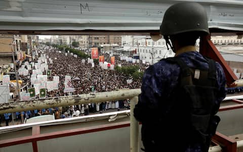 epa10797328 A Houthi trooper stands guard during a rally commemorating the anniversary of the killing of Shiite Imam Zaid bin Ali, in Sana'a, Yemen, 12 August 2023. The mass rally was held in the Houthi-controlled capital of Sana'a to mark the anniversary of the killing of Shiite Imam Zaid bin Ali who was a direct descendant of Prophet Muhammad. Imam Zaid was killed in the Iraqi city of Kufa in AD 740 when he led an uprising against the Umayyad rule.  EPA/YAHYA ARHAB