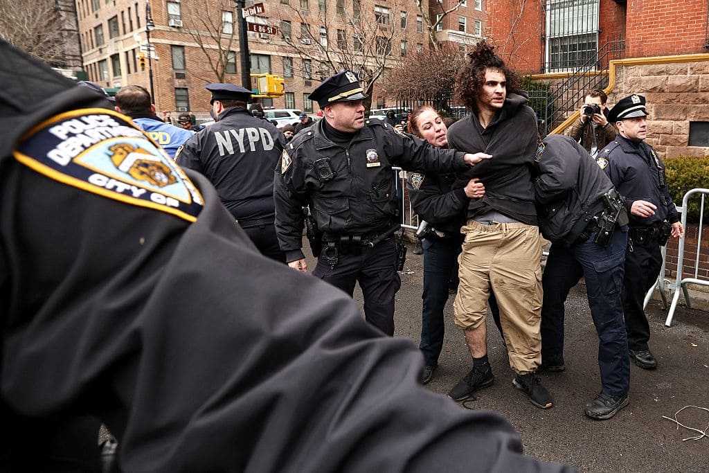 A left-wing activist is detained by police after throwing a homemade explosive device towards police during a protest organized by far-right influencer Jake Lang against alleged "Islamification" and to ask for a "stop of public Muslim prayer" in New York, in front of Gracie Mansion, New York mayor Zohran Mamdani's official residence, in New York on March 7, 2026. (Photo by CHARLY TRIBALLEAU / AFP via Getty Images)