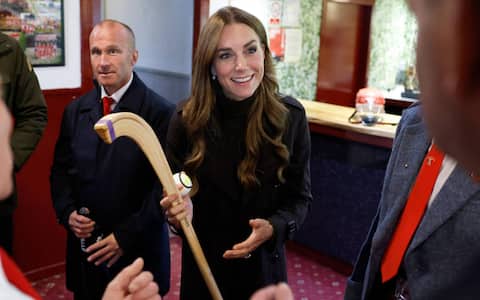 Britain's Catherine (C), Princess of Wales, meets representatives from the club's senior and youth teams, while visiting Bute Shinty Club in Rothesay, in the Isle of Bute, Scotland, on September 17, 2026. (Photo by Jeff J Mitchell / POOL / AFP)