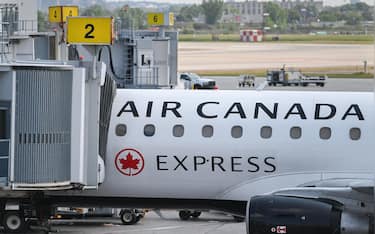 epa12300332 An Air Canada plane at a gate at Montreal-Trudeau International Airport, in Montreal, Quebec, Canada, 14 August 2025. Air Canada is facing a near-total shutdown, as the union plans to strike after talks with flight attendants broke down over pay and unpaid work.  EPA/GRAHAM HUGHES