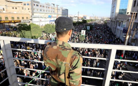 epa10929460 A Houthi soldier keeps watch as Yemenis take part in a rally in solidarity with the Palestinian people, in Sana'a, Yemen, 20 October 2023. Thousands of Israelis and Palestinians have died since the militant group Hamas launched an unprecedented attack on Israel from the Gaza Strip on 07 October 2023, leading to Israeli retaliation strikes on the Palestinian enclave.  EPA/YAHYA ARHAB