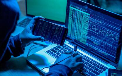 Hacker with computers in dark room. Cyber crime