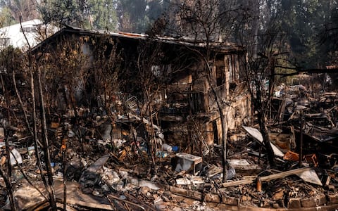 epaselect epa13141076 Damage at a burnt house at Pelayos de la Presa in Madrid, Spain, 30 July 2026. Firefighters continue to battle the remaining fire hotspots of the wild fire in Madrid that started last 23 July when a vehicle caught fire on the M-501 road at San Martin de Valdeiglesias, Madrid.  EPA/Chema Moya