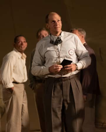 Front Row L to R: Gustaf Skarsgård is Hans Bethe, Matthew Modine is Vannevar Bush, and Danny Defarrari is Enrico Fermi in OPPENHEIMER, written, produced, and directed by Christopher Nolan.