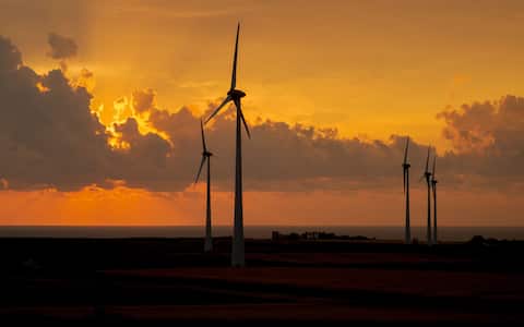 2H3WCB0 Silhouette of wind turbines in front of the sea at sunrise; Isola di Capo Rizzuto, Crotone, Calabria, Italy
