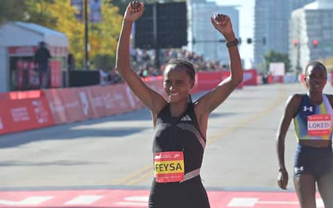 CHICAGO, ILLINOIS - OCTOBER 11: Ethiopian runner Hawi Feysa crosses the finish line to win the women's professional division at the 48th Bank of America Chicago Marathon in Chicago, United States on October 11, 2026. Over 55,000 participants competed on the 26.2-mile course starting and finishing in Grant Park. (Photo by Jacek Boczarski/Anadolu via Getty Images)