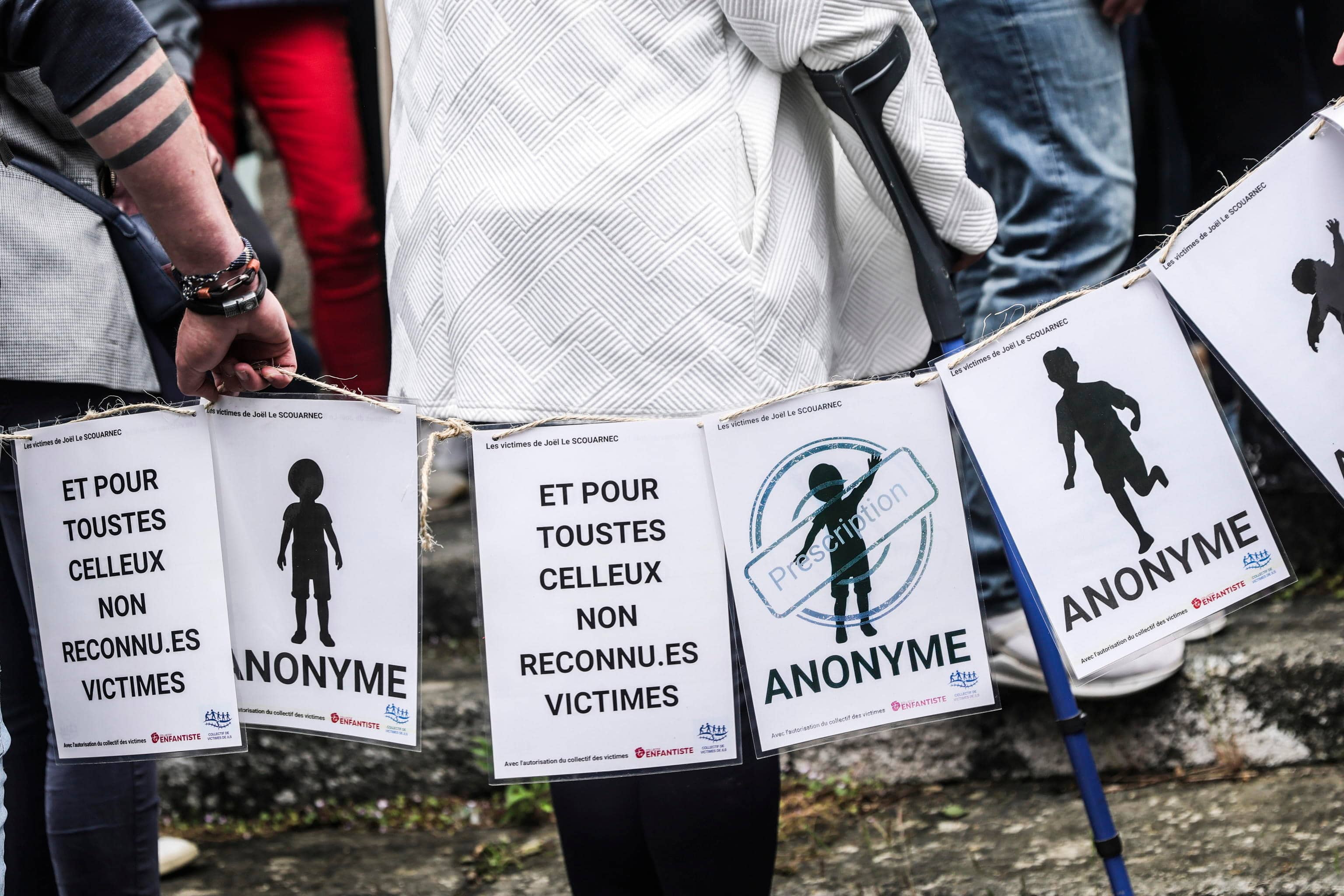 epa12140685 People, including victims, carry banners representing the victims of Joel Le Scouarnec on the verdict day of the trial of the French surgeon in Vannes, France, 28 May 2025. A French court on 28 May handed retired surgeon Joel Le Scouarnec a 20-year sentence for the rape and aggravated sexual assault of 299 victims, most of them minors, crimes committed between 1986 and 2014.  EPA/TERESA SUAREZ