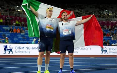 BIRMINGHAM, ENGLAND - AUGUST 10: Gold medalist Leonardo Fabbri of Team Italy, Silver medalist Zane Weir of Team Italy pose for a photo with the national flags, after competing in the Men's Shot Put Final during day one of the 27th European Athletics Championships at Alexander Stadium on August 10, 2026 in Birmingham, England. (Photo by Sona Maleterova/Getty Images)