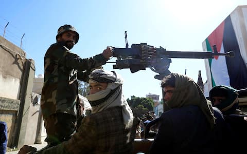 epa10915212 Houthi fighters riding a truck with a machine gun patrol near the Yemen-based office of the Islamic movement Hamas during a military parade in solidarity with Palestinians in the Gaza Strip, in Sana'a, Yemen, 12 October 2023. The top leader of the Houthis movement, Abdul-Malik al-Houthi, has warned that his movement will stand ready to engage in hostilities against Israel should the United States directly back the Israeli military campaign on the Gaza Strip. Thousands of Israelis and Palestinians have died since the militant group Hamas launched an unprecedented attack on Israel from the Gaza Strip on 07 October 2023, leading to Israeli retaliation strikes on the Palestinian enclave.  EPA/YAHYA ARHAB