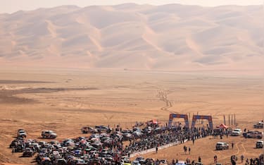 Competitors gather at the start, delayed due to foggy conditions, of Stage 11 of the Dakar Rally 2025, between Shubaytah and Shubaytah, Saudi Arabia, on January 16, 2025. (Photo by Valery HACHE / AFP) (Photo by VALERY HACHE/AFP via Getty Images)