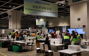 epa12577663 Staff of the electoral Affairs Commission (EAC) count ballots at a counting zone following the Legislative Council General Election of the 07 of December, in Hong Kong, China, 08 December 2025. Hong Kong's 'patriots-only' Legislative Council election is held as the city mourns the deadly Wang Fuk Court fire in Tai Po, with public calls for accountability amid lingering questions about the tragedy.  EPA/MAY JAMES
