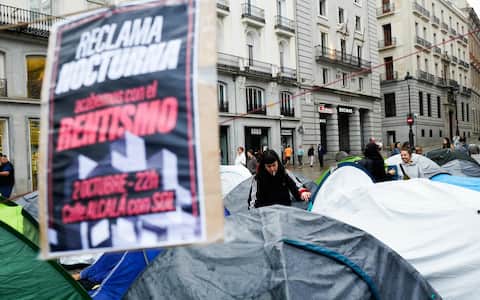 epa13278194 Demonstrators wake up on the seventh day of a protest encampment at Puerta del Sol in Madrid, Spain, 03 October 2026, a day after housing decrees introduced by the Spanish government to address the country's housing affordability crisis failed to pass in the Lower Chamber of Parliament. The nationwide protests against the ongoing housing crisis were sparked by the eviction of an 87-year-old woman from her rental home after 70 years on 23 September 2026.  EPA/Borja Sanchez-Trillo