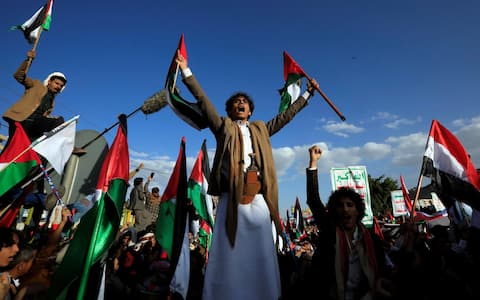 epa10929458 Yemenis with Palestinian flags shout slogans during a rally in solidarity with the Palestinian people, in Sana'a, Yemen, 20 October 2023. Thousands of Israelis and Palestinians have died since the militant group Hamas launched an unprecedented attack on Israel from the Gaza Strip on 07 October 2023, leading to Israeli retaliation strikes on the Palestinian enclave.  EPA/YAHYA ARHAB