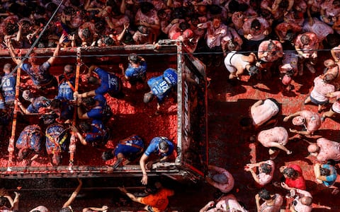 IPA87805768 - August 26, 2026, BuÃ±Ol, Valencia (Valencian Comm, Spain: Several participants in the Tomatina festival in BuÃ±ol throw tomatoes from a lorry at the other revellers on 26 August 2026, in BuÃ±ol, Valencia, the Valencian Community (Spain). La Tomatina is always held on the last Wednesday in August, as part of BuÃ±olâ€™s festival week, and involves participants throwing tomatoes at one another. Seven lorries were needed to transport the 150,000 kilos of tomatoes that were thrown during this unusual battle, which this year marks its 79th anniversary...26 AUGUST 2026;CELEBRATIONS;TRADITION;FESTIVAL;EVENT;CULTURE..Rober Solsona / Europa Press..08/26/2026 (Credit Image: © Rober Solsona/Contacto via ZUMA Press)