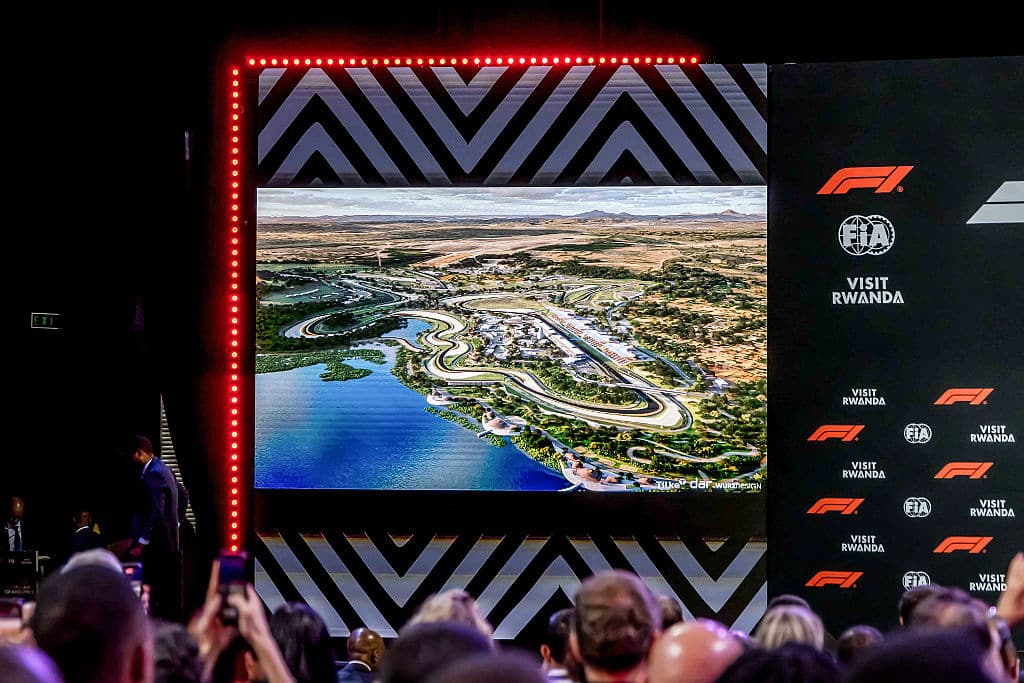 TOPSHOT - Attendees follow a presentation as a render of the proposed Formula 1 circuit in Rwanda is displayed on giant screens during the announcement of the Formula 1 African Grand Prix at BK Arena in Kigali on October 13, 2026. Rwanda will host Africa's first Formula One Grand Prix since 1993 in "the early 2030s" after the circuit announced a 10-year deal with the country on October 13, 2026. 
"Today is a landmark moment for Formula One," F1 president Stefano Domenicali said in a statement. (Photo by Jean Baptiste Nkurunziza / AFP via Getty Images)