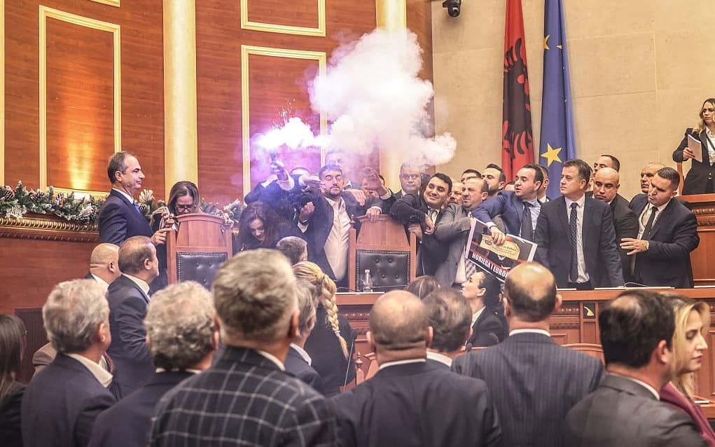 TIRANA, ALBANIA - DECEMBER 18: Opposition law makers of Democratic Party of Albania light flares as a protest against election of new ombudsman on December 18, 2025 in Tirana, Albania. The MPs were protesting the election of Endrit Shabani as Albania's new ombudsman. The role, also known as the people's advocate, "defends the rights, freedoms and lawful interests of individuals from unlawful and incorrect acts" by government bodies. (Photo by Armando Babani/Getty Images)
