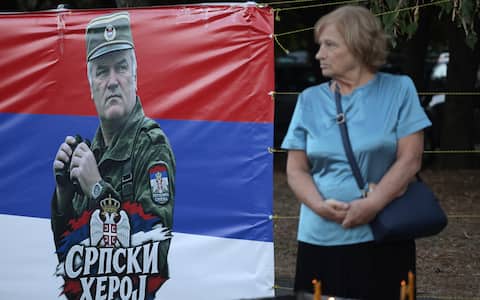 epa13218921 A woman stands next to a banner reading 'Serbian Hero' depicting Ratko Mladic during his funeral in Belgrade, Serbia, 07 September 2026. Former Bosnian Serb general Ratko Mladic, who was convicted of war crimes by the International Criminal Tribunal for the Former Yugoslavia (ICTY) in 2017, died on 27 August 2026 at the age of 84.  EPA/ANDREJ CUKIC