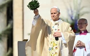 Pope Leo XIV blesses the crowd during the Easter Mass as part of the Holy Week celebrations, at St Peter's square in the Vatican on April 5, 2026. (Photo by Alberto PIZZOLI / AFP)