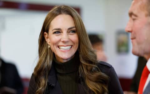 Britain's Catherine (C), Princess of Wales, smiles as she meets representatives from the club's senior and youth teams, while visiting Bute Shinty Club in Rothesay, in the Isle of Bute, Scotland, on September 17, 2026. (Photo by Jeff J Mitchell / POOL / AFP)