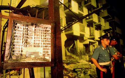 PALERMO, ITALY - JULY 19:  Carabinieri stand in front of the door phone of Via D'Amelio that triggered the mafia bombing which killed Italian anti-mafia judge Paolo Borsellino and five members of his police escort on July 19, 1992 in Palermo, Italy.  (Photo by Franco Origlia/Getty Images)