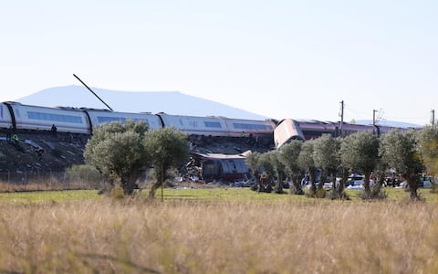 epa13336234 A general view showing the derailed carriages of the two high-speed trains (AVE in Spanish symbols), one of Renfe and another of Iryo, that have crashed in the village of Urda, Toledo, Spain, 28 October 2026. At least ten people have been killed, Spanish media reported.  EPA/ISMAEL HERRERO