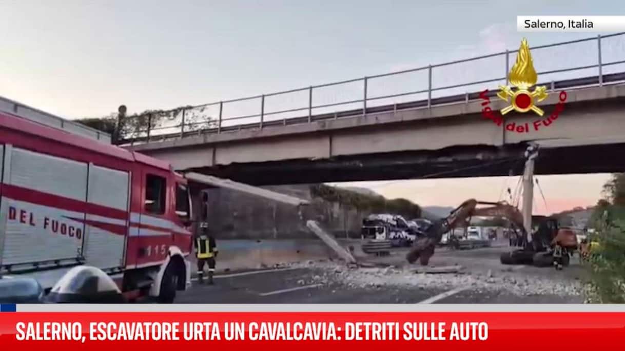 Truck carrying excavator hits overpass near Salerno, sending concrete debris onto cars