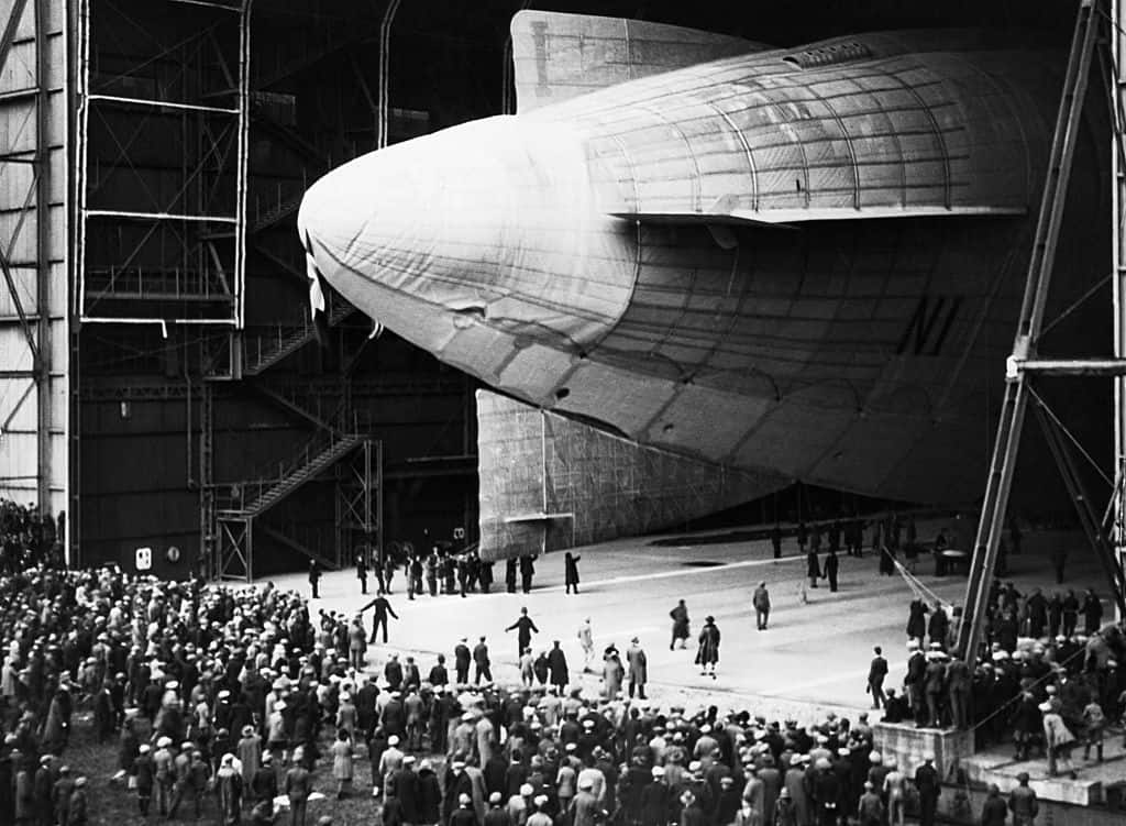 The stern of the Norge, juts out from a hangar in Pulham, England, before leaving for Olso, Norway. ca. 1900 | Location: Pulham, Norfolk, England. (Photo by © CORBIS/Corbis via Getty Images)