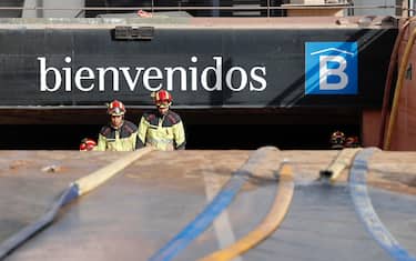 epa11698481 Firefighters exit a flooded underground parking garage at Bonaire mall in Valencia, eastern Spain 03 November 2024. Rains have left more than 200 dead, an undetermined number of missing people, and widespread damage, especially in the province of Valencia. Thousands of volunteers are helping in a day that culminates in the largest deployment of military and security forces personnel in peacetime, according to the Spanish prime minister.  EPA/Manuel Bruque