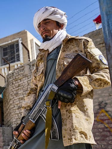 TOPSHOT - An Armed Taliban security personnel stands guard near the closed gate of the zero point border crossing between Afghanistan and Pakistan at Spin Boldak district in Kandahar province on October 12, 2025. Afghanistan and Pakistan said on October 12, they killed dozens of each other's troops during a night of heavy border clashes between the two countries. (Photo by Sanaullah SEIAM / AFP) (Photo by SANAULLAH SEIAM/AFP via Getty Images)          