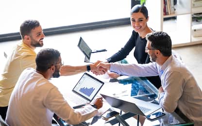 Successful business meeting between business owners and customer in modern office, handshake, agreement, new business