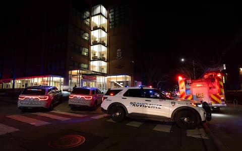 PROVIDENCE, RHODE ISLAND  DECEMBER 13: Emergency responders work at the scene near Brown University in Providence, Rhode Island, on December 13, 2025, following a mass shooting that left at least two people dead and eight others injured. Authorities said police launched a search for the suspect, who remained at large, while campus officials urged students and staff to shelter in place as the investigation continued. (Photo by Lokman Vural Elibol/Anadolu via Getty Images)