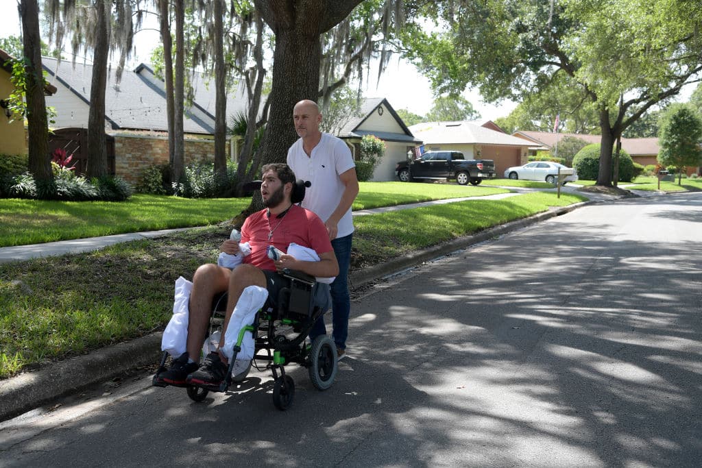 WINTER PARK, FL-MAY 22: Former professional boxer Prichard Colon is taken for a stroll by his father Richard Colon around the neighborhood in Winter Park, Fla., Monday, May 22, 2017. Prichard Colon remains in a vegetative state after suffering a traumatic brain injury during his bout against Terrel Williams. (Photo by Phelan M. Ebenhack/For The Washington Post via Getty Images)