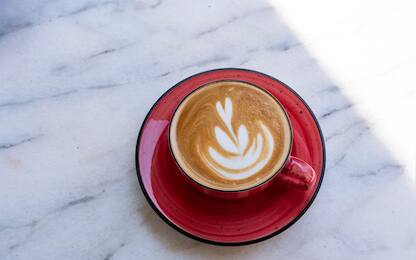 cafe latte art on milk foam with hand made ceramic coffee cup