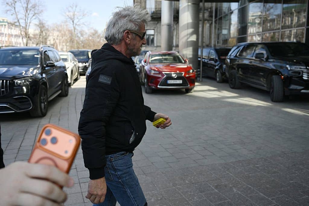 US actor Sean Penn walks down a street in Kyiv on March 16, 2026, amid the Russian invasion of Ukraine. Sean Penn, who scored an Oscar for best supporting actor for "One Battle After Another" on March 15, 2026, is in Ukraine to show support to the war-torn country, a senior Ukrainian official told AFP. Penn -- a vocal advocate for Ukraine who had visited the country several times -- has won his third acting Oscar but was not at the ceremony. (Photo by Genya SAVILOV / AFP via Getty Images)