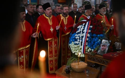 A portrait of late Bosnian Serb military leader Ratko Mladic is displayed on his coffin at the end of his funeral ceremony at St Lukas church in Belgrade on September 7, 2026. Mladic, 84, died last week after suffering several strokes while serving a life sentence in The Hague for war crimes committed during the 1990s war in Bosnia. (Photo by OLIVER BUNIC / AFP)
