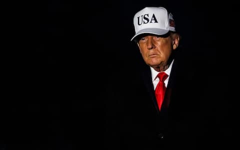 US President Donald Trump walks on the South Lawn of the White House after arriving on Marine One in Washington, DC, US, on Saturday, Dec. 13, 2025. Trump responded to questions following the Brown University shooting, stating "What a terrible thing it is. All we can do right now is pray for the victims. It's a shame." Photographer: Samuel Corum/Sipa/Bloomberg