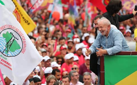 epa10274105 Brazilian presidential candidate Luiz Inacio Lula da Silva (R) smiles during a campaign tour through the streets of Sao Paulo, Brazil, 29 October 2022. Brazilians will go to the polls 30 October to decide between Lula or his rival, current President Jair Bolsonaro, as head of State for the 2022-2026 period.  EPA/Sebastiao Moreira