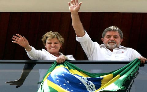 SBC60 - 20021027 - SAO BERNARDO DO CAMPO, BRAZIL : Brazilian presidential candidate Luiz Inacio Lula da Silva (R), of the Worker's Party (PT), and his wife Marisa, wave to supporters from his flat balcony, Sunday 27 October 2002, after casting his ballot in Sao Bernardo do Campo. Polls opened early 27 October in Brazil where 115 million voters were to pick the next president.  EPA PHOTO  AFPI / DANIEL GARCIA /as/mm/jim