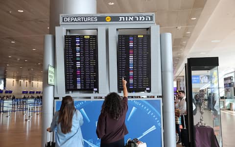 epa13272702 Passengers check a flight board at Ben Gurion International Airport near Tel Aviv, Israel, 30 September 2026. A Flydubai spokesperson confirmed that flight FZ 1073 from Dubai to Tel Aviv 'experienced an incident while en route' and was safely diverted to Tabuk Airport (TUU) in Saudi Arabia following a flight deck altercation.  EPA/ABIR SULTAN EPA