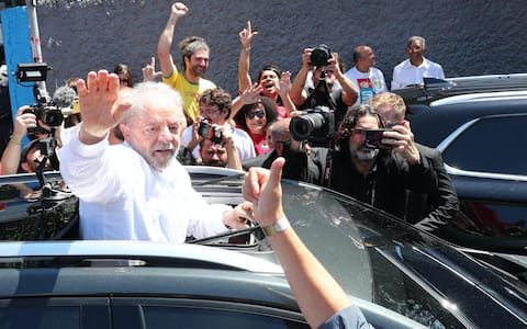 epa10275107 Former Brazilian president and presidential candidate Luiz Inacio Lula da Silva greets his departure after voting in the second round of the presidential elections in Sao Bernardo do Campo, Sao Paulo, Brazil, 30 October 2022. Brazilians headed to polling stations on 30 October to decide between former President Luiz Inacio Lula da Silva or his rival, current President Jair Bolsonaro, as head of State for the 2022-2026 period.  EPA/Antonio Lacerda